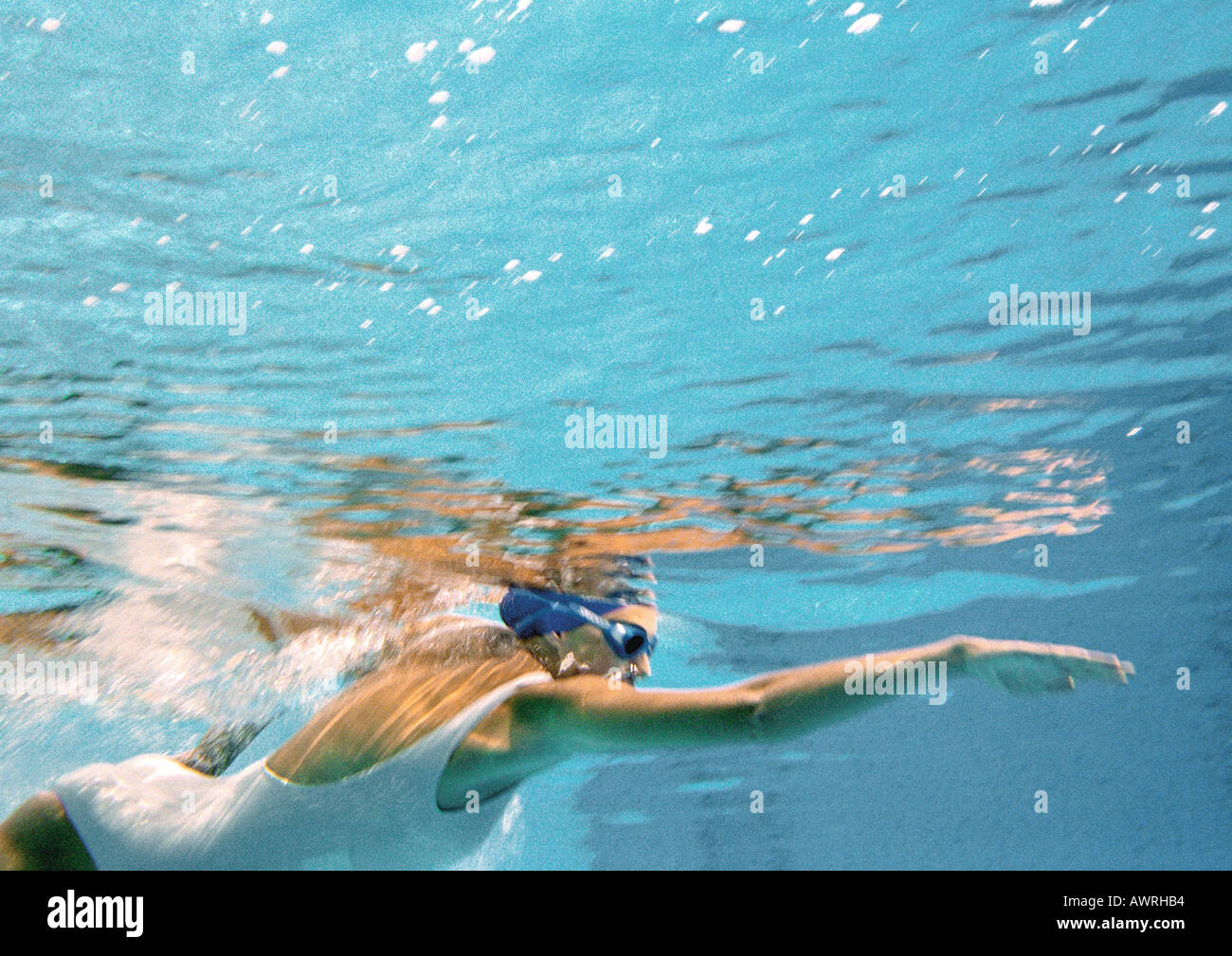 Woman swimming underwater, underwater view. Stock Photo