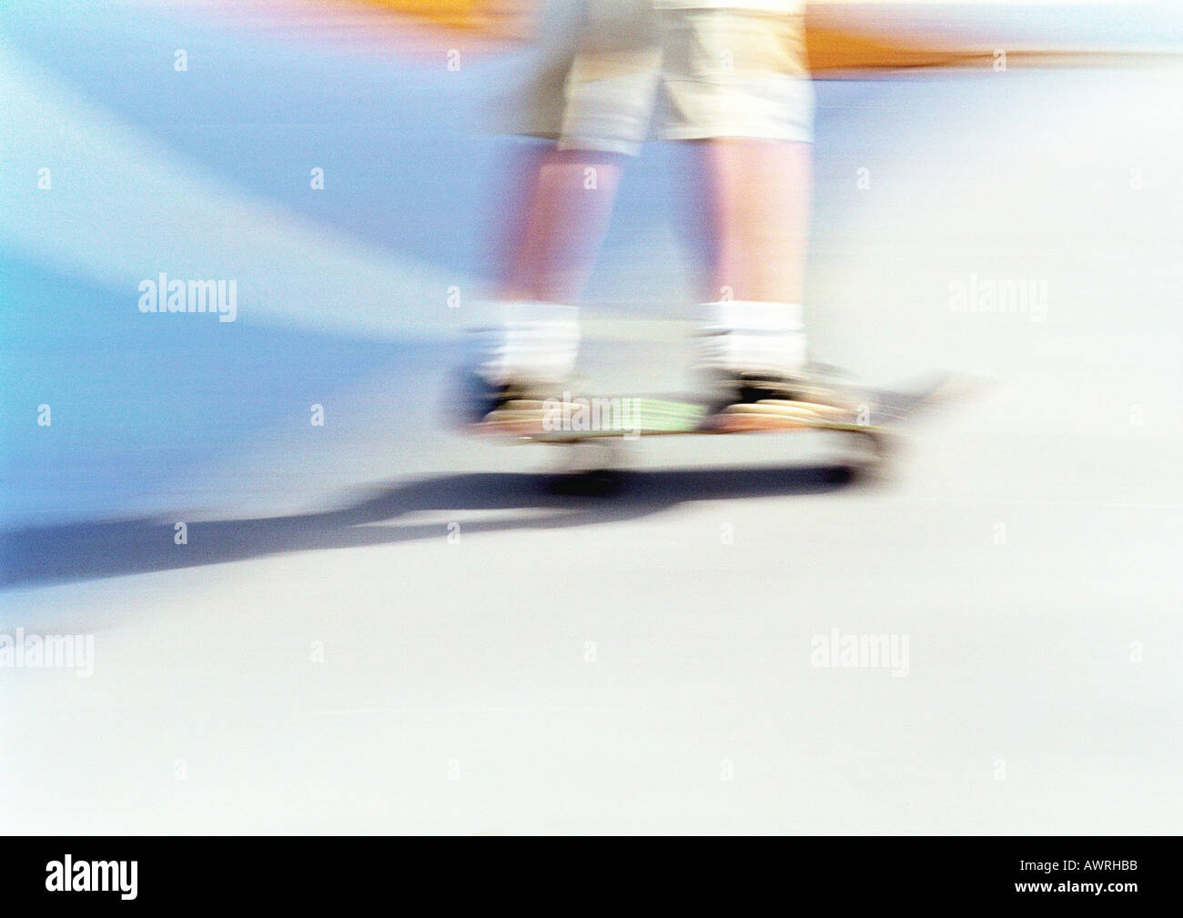 Man skateboarding, low section, blurred. Stock Photo