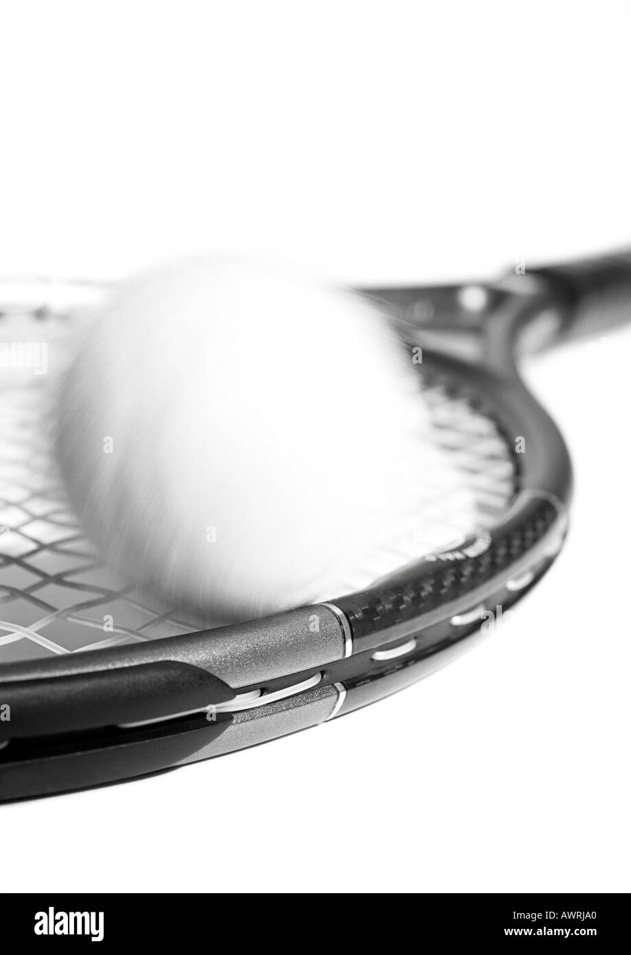 Tennis racket and ball, blurred, close-up, b&w. Stock Photo