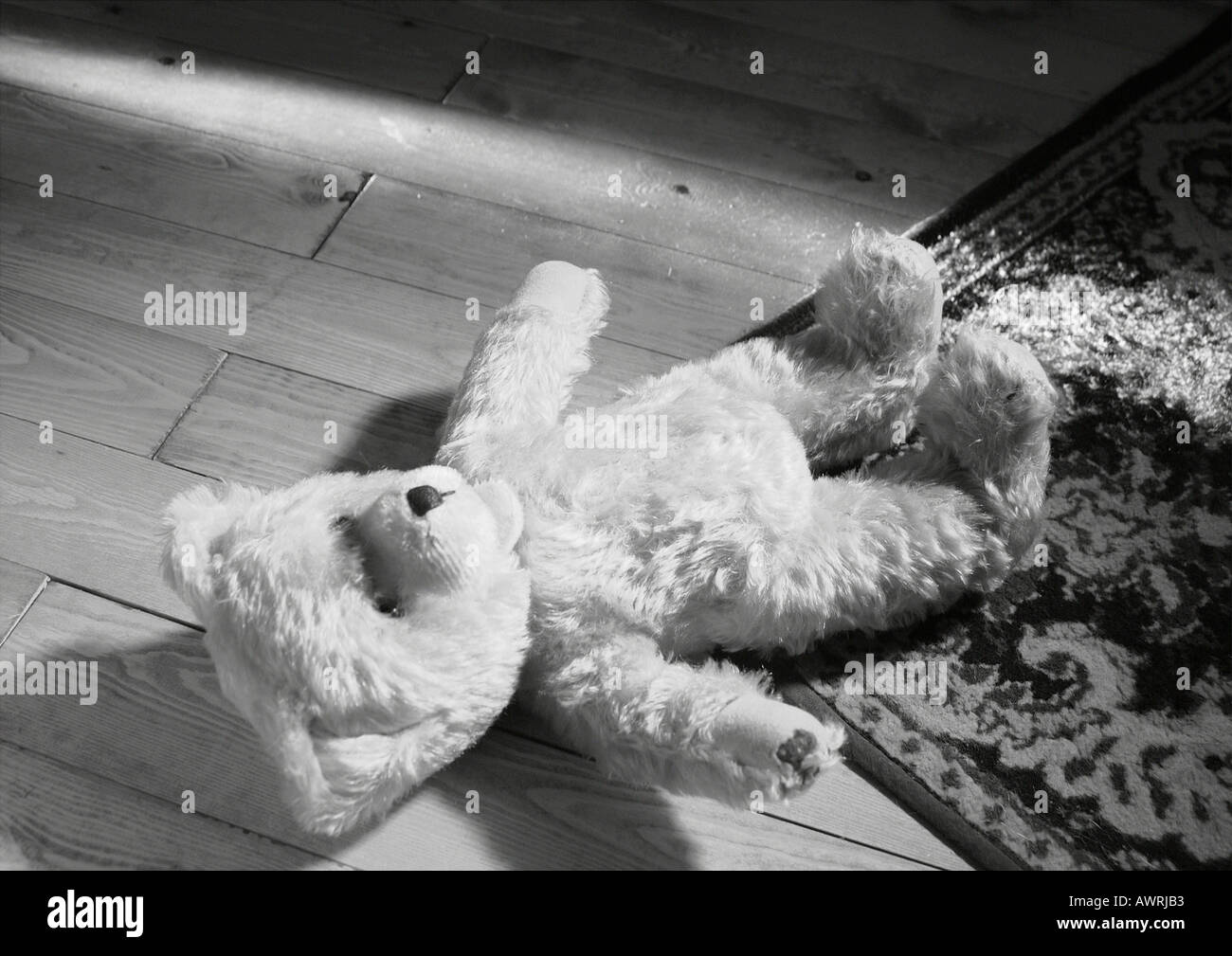 Teddy bear lying on the floor Stock Photo - Alamy