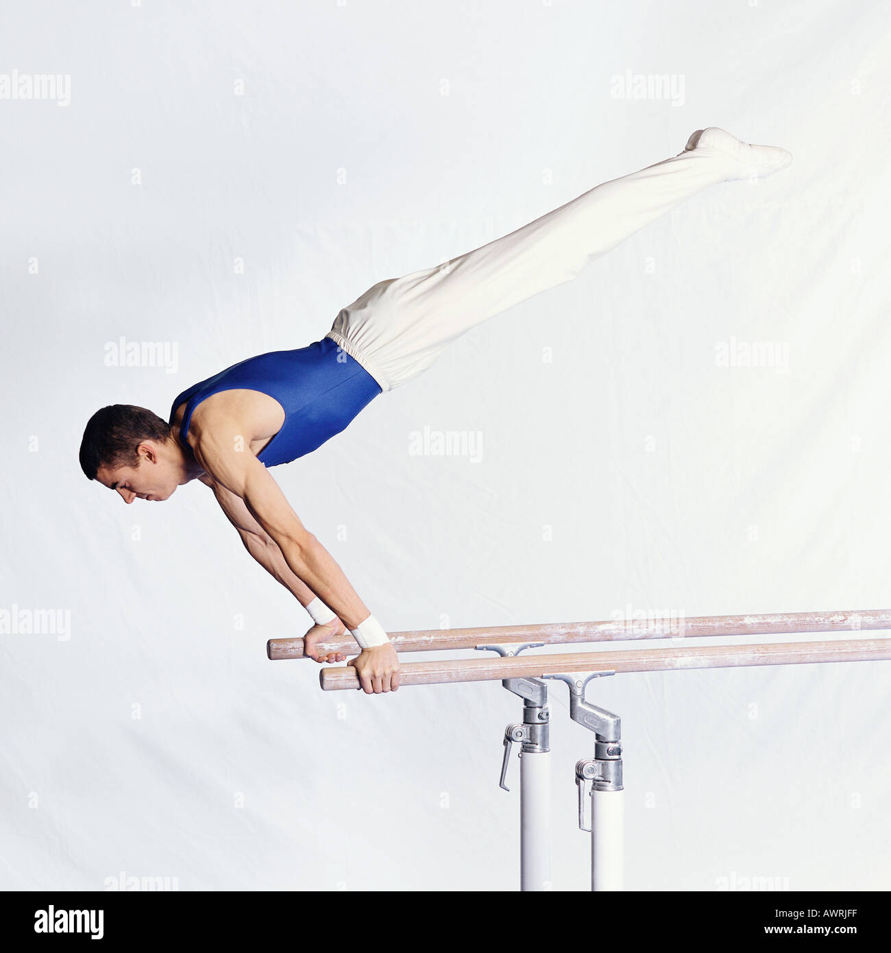 Young male gymnast performing routine on parallel bars Stock Photo Alamy