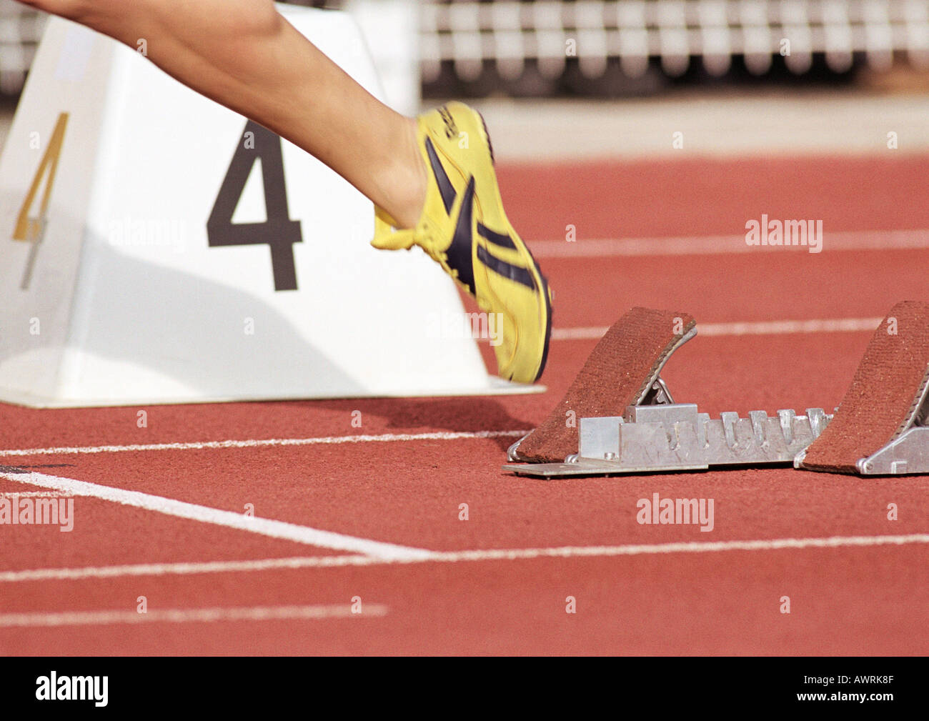 Runner leaving starting block, low section, close-up Stock Photo - Alamy