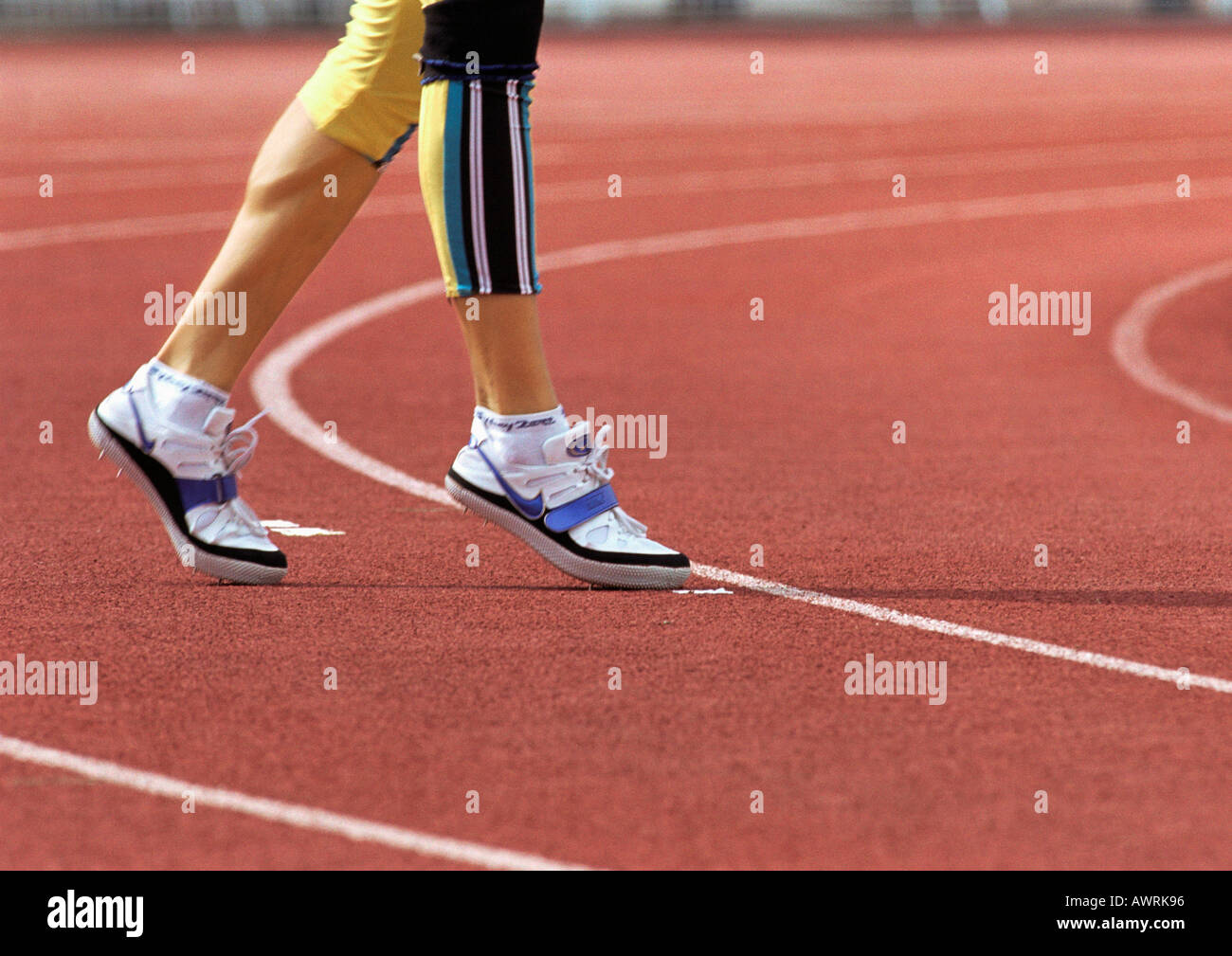 Young female athlete in pink sports outfit jogging on the steppe