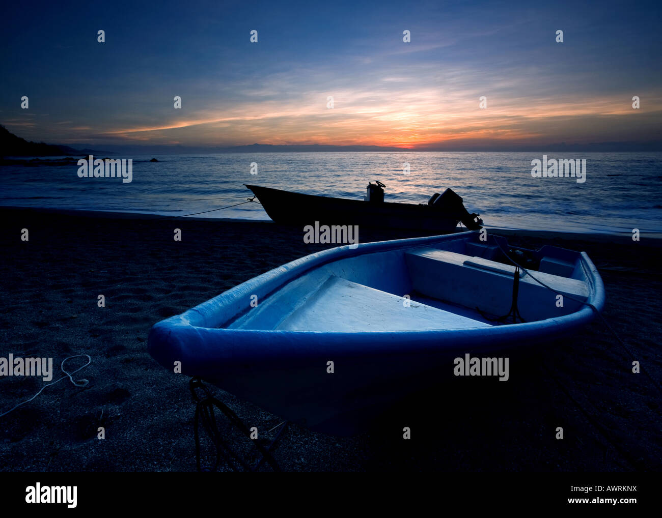 Two boats at sunrise in Montezuma, Costa Rica Stock Photo