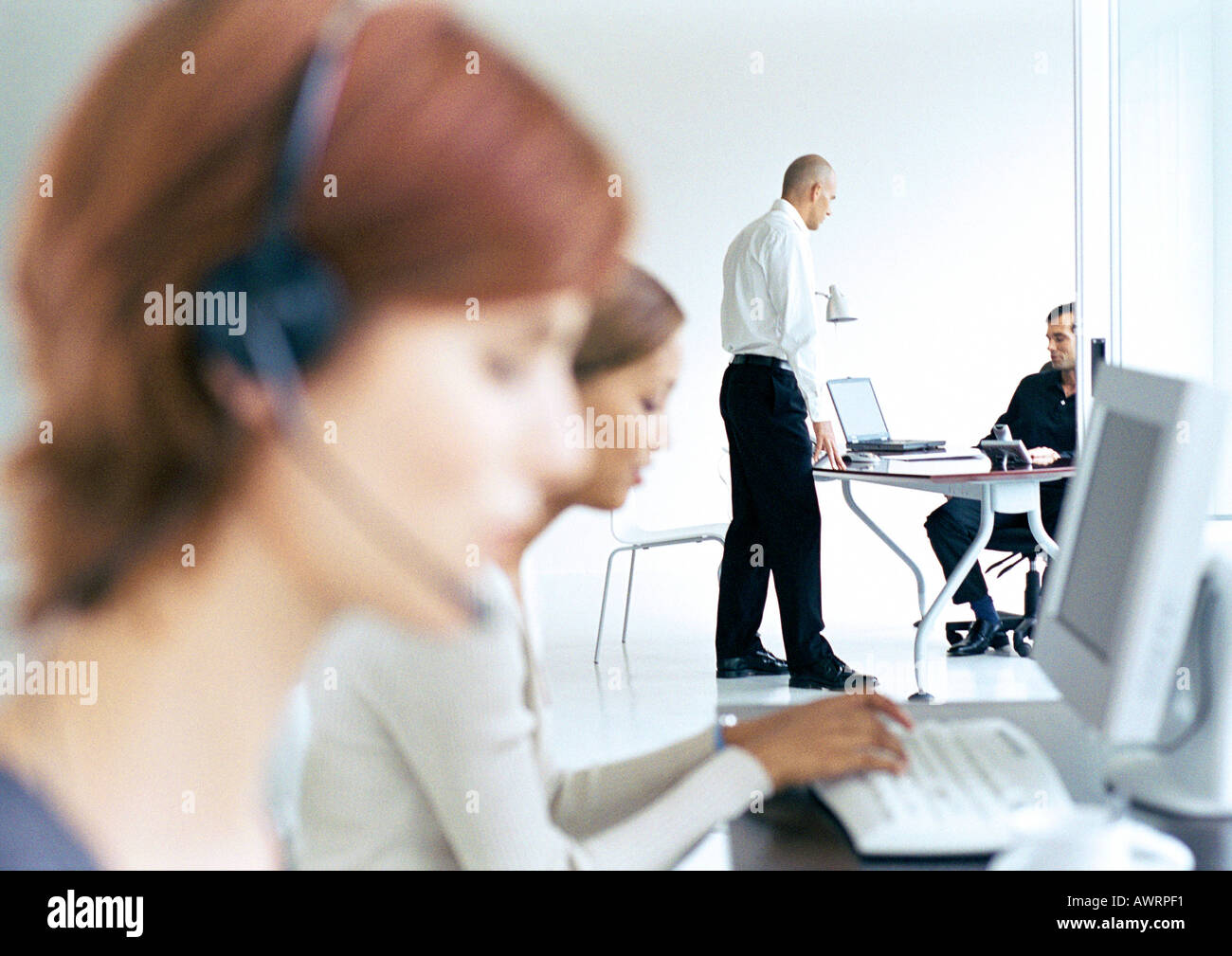Business people in office, blurred foreground Stock Photo