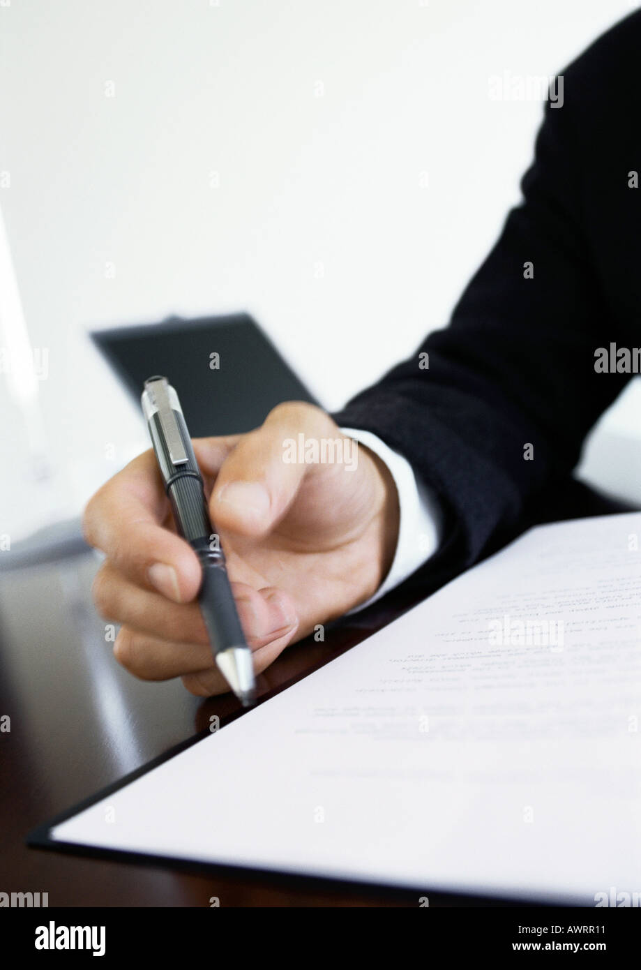 Hand holding pen, close-up Stock Photo