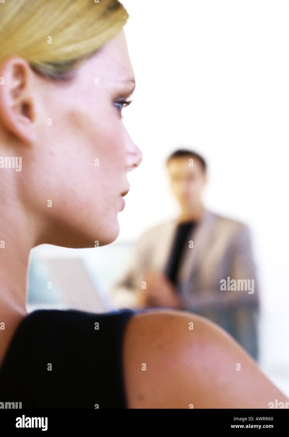 Businessman and woman, close-up of woman's head and shoulder, rear view Stock Photo