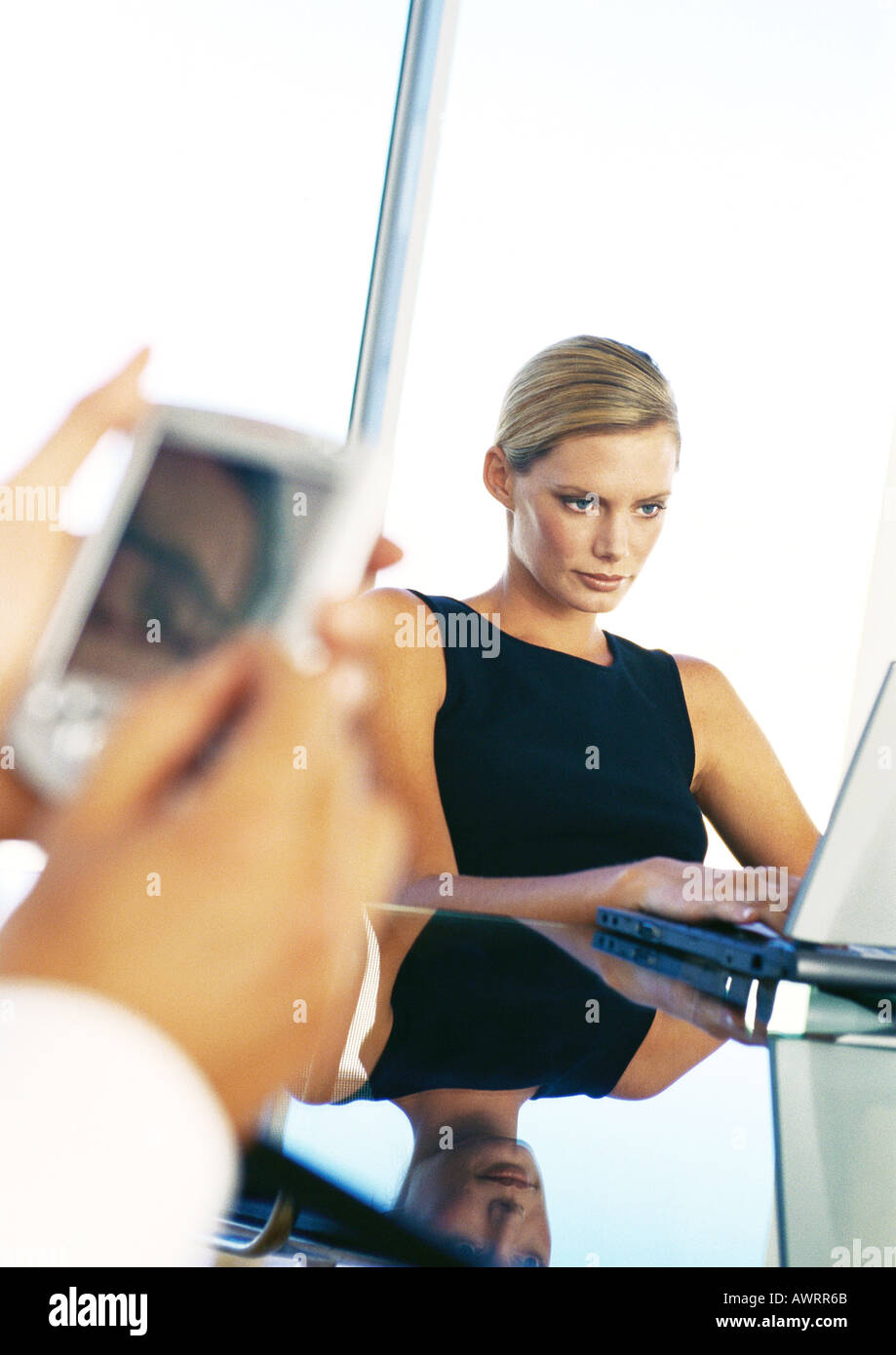 Businesswoman using computer, hands holding pocket computer Stock Photo
