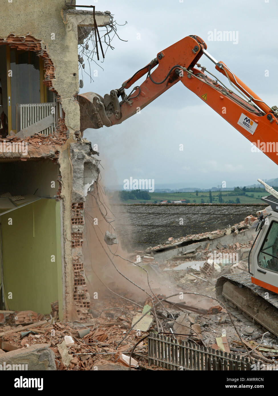 demolition of a building breaking a house with a digger at a building