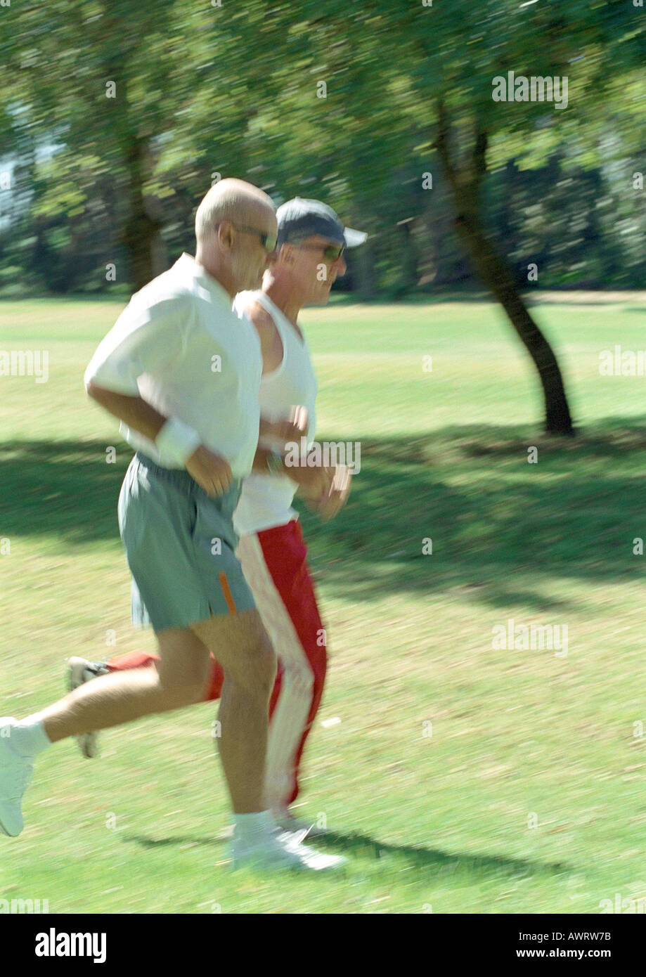 Two mature joggers in park, side view Stock Photo
