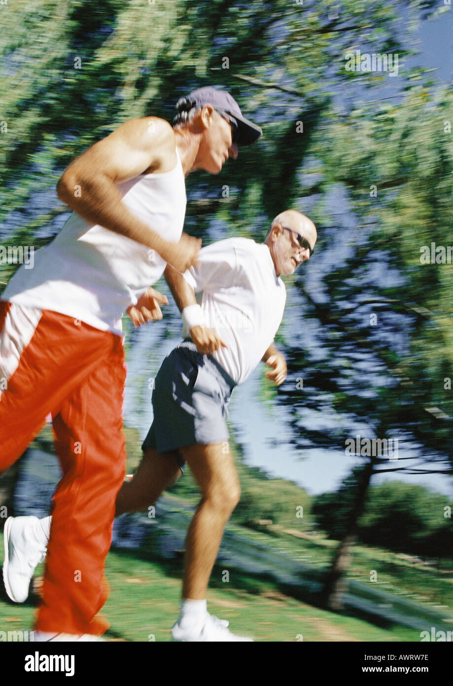 Two mature joggers in park, low angle view Stock Photo