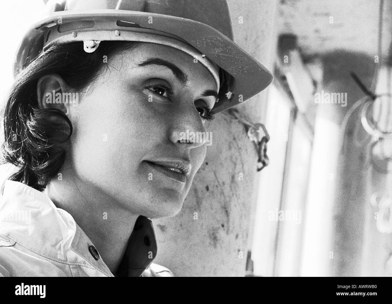 Woman wearing hard hat, close-up, b&w Stock Photo