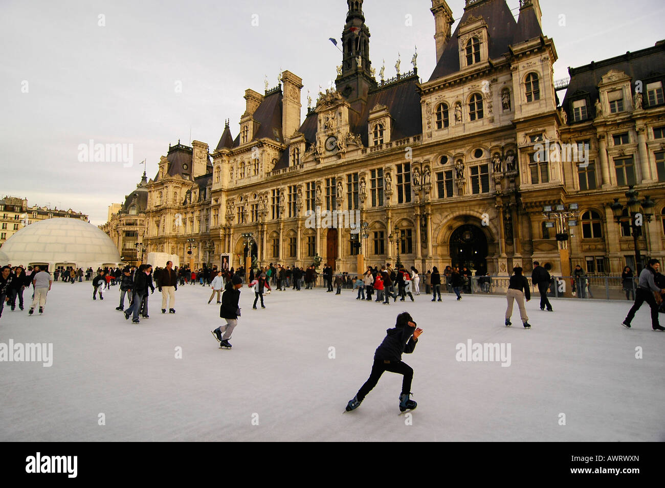 People ice skating in front of the "Hotel de Ville" (city hall), a