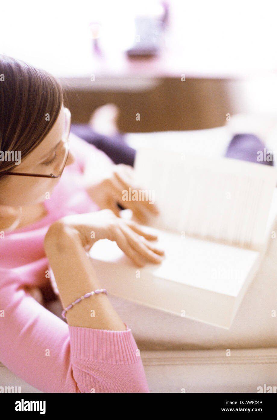 Woman reading book, side view Stock Photo