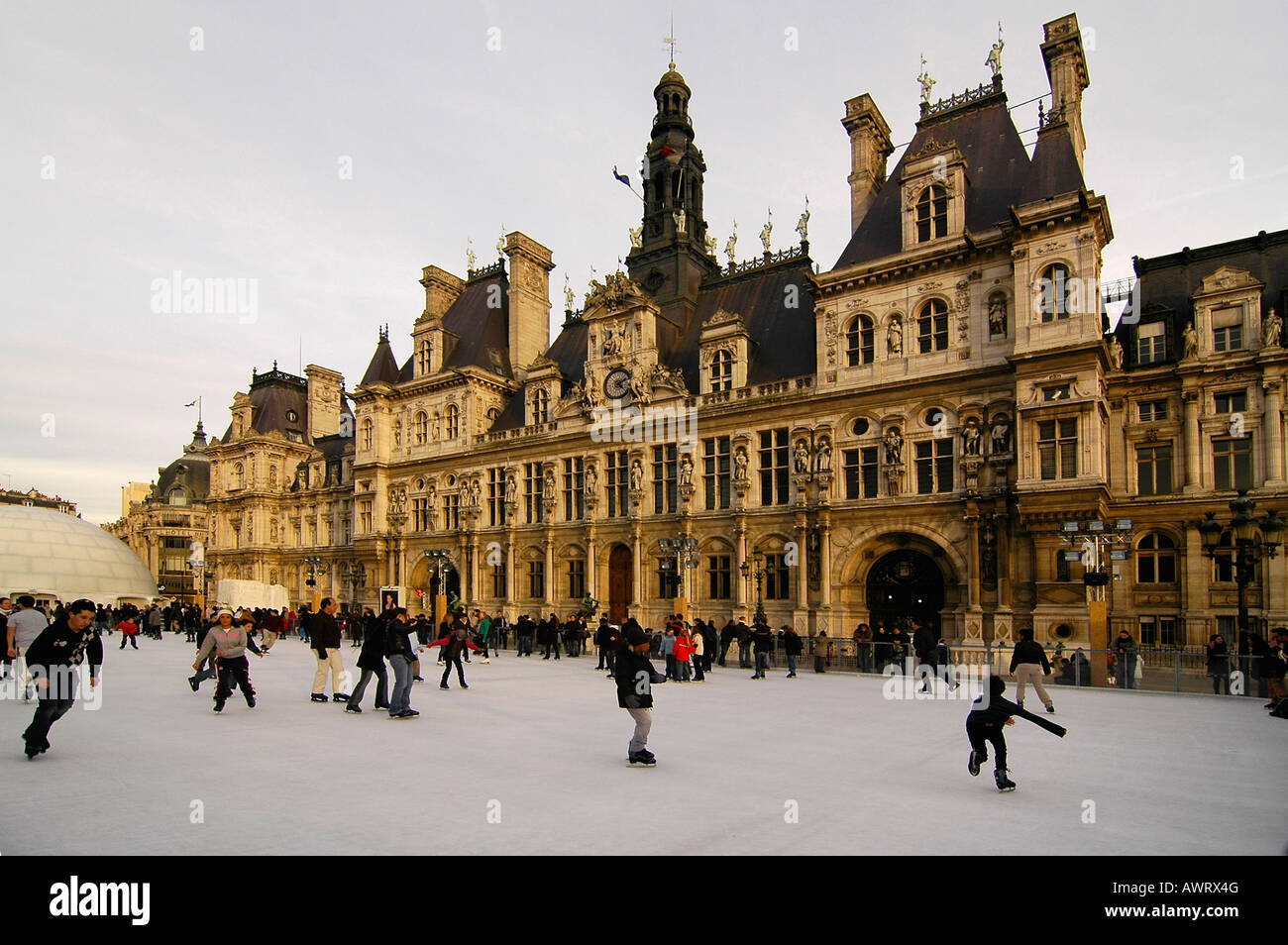 People ice skating in front of the "Hotel de Ville" (city hall), a