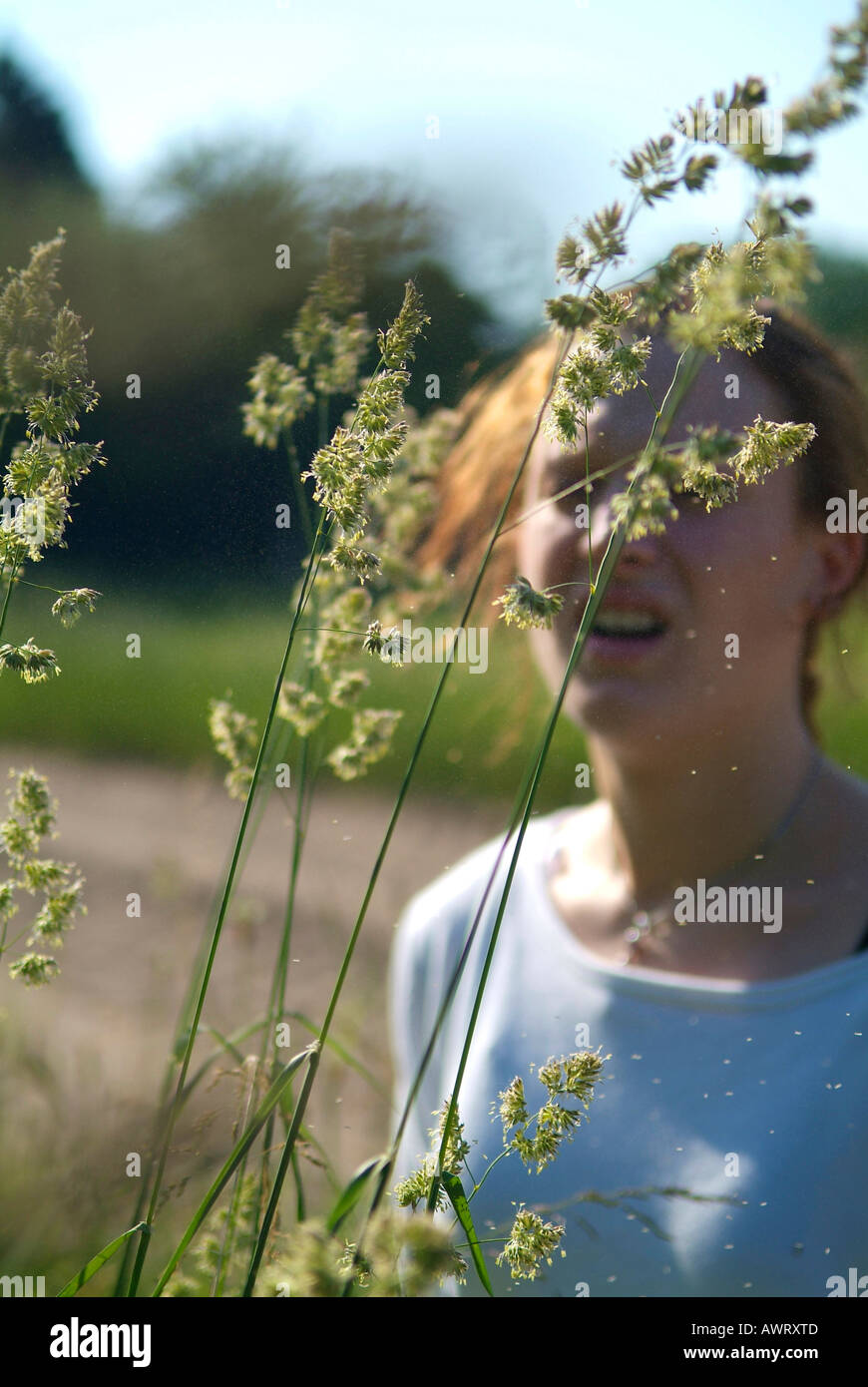 Young woman with hay fever reacts allergic to grass and pollen dactylis