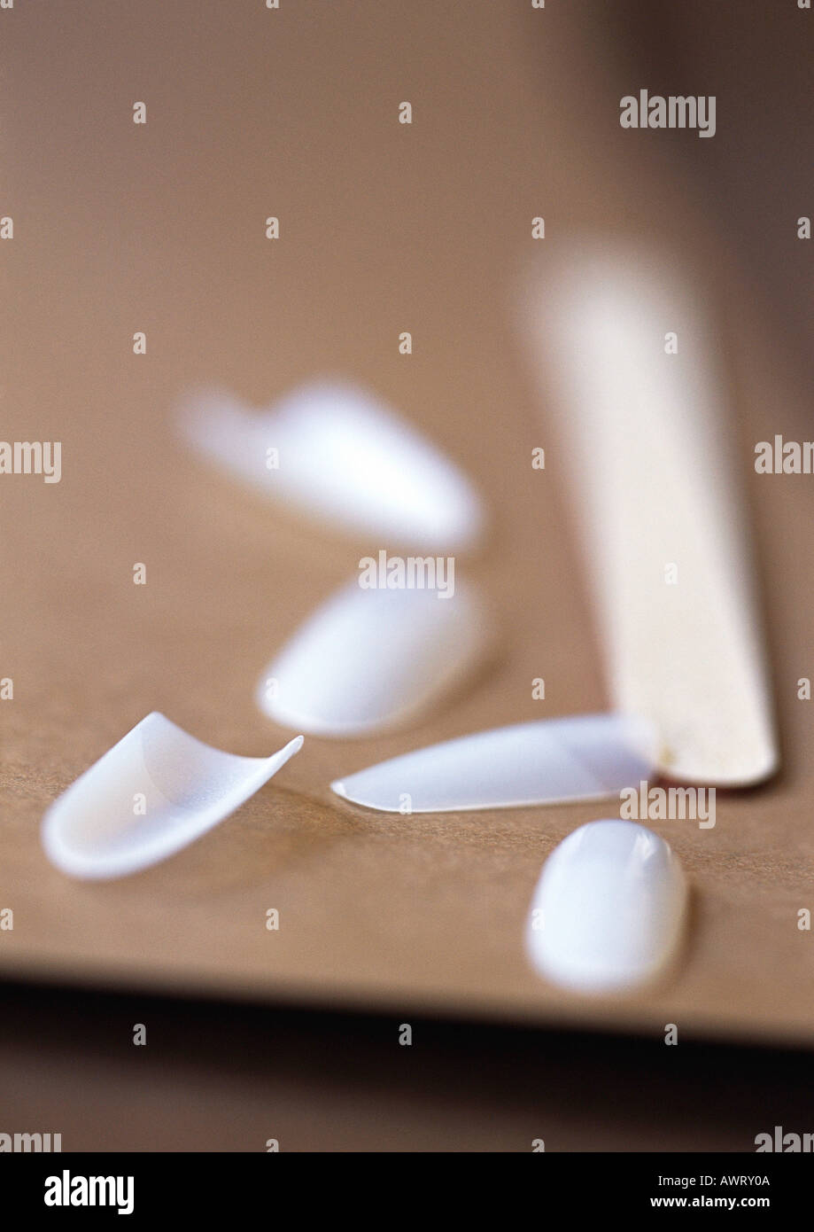 Fake fingernails and fingernail file, close-up, blurred Stock Photo