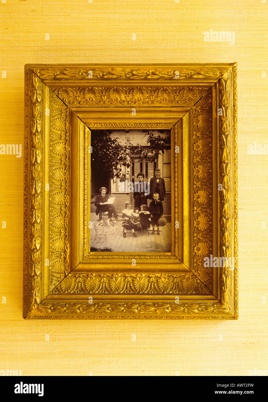 1905's vintage photo of a family in a golden frame Stock Photo