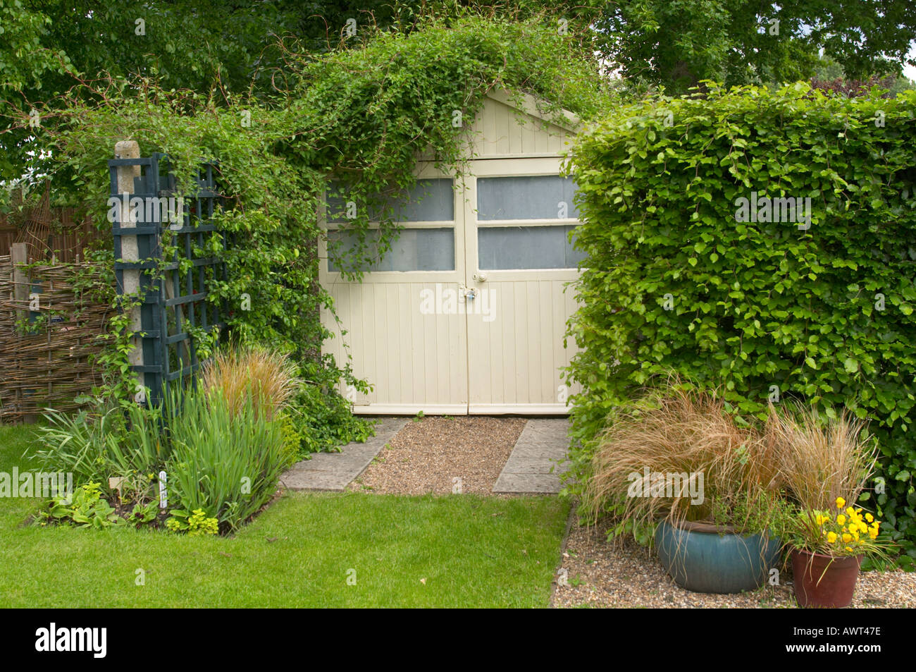Garage with plants growing over the roof Stock Photo Alamy