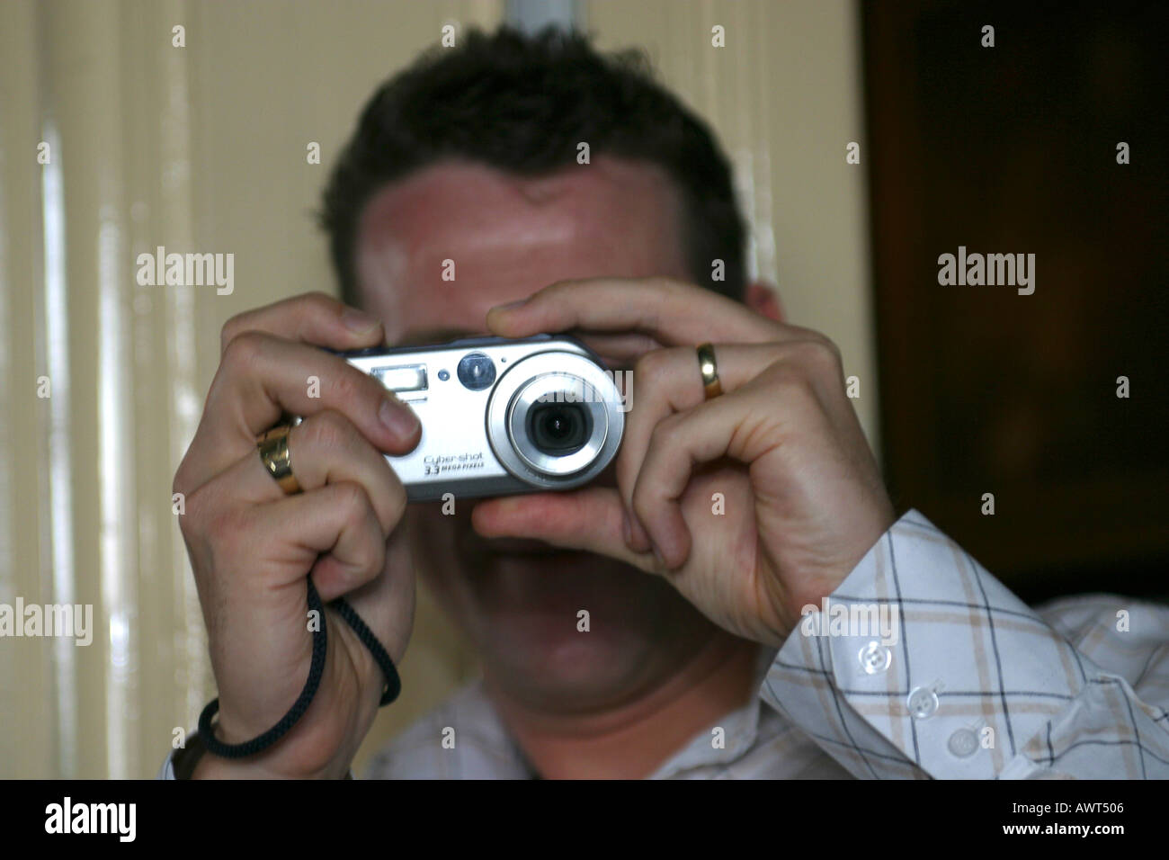 Man taking a picture with a digital compact camera Stock Photo
