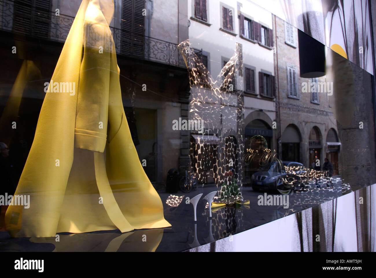 Window display of upmarket fashion shop in Corso Italia, Arezzo Tuscany Italy, with the reflection of the street architecture. Stock Photo