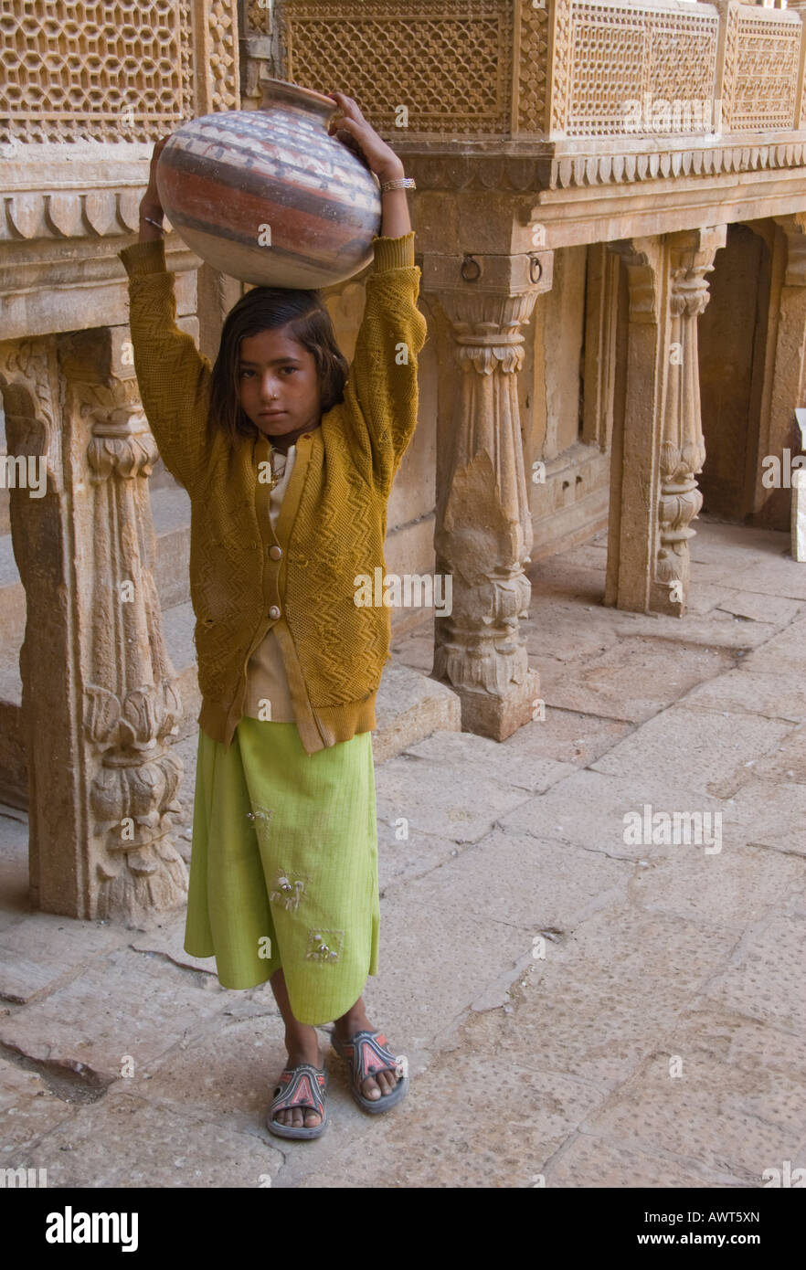 Portrait of a young girl carrying a water jug in Jaisalmer, Rajasthan, India. Stock Photo