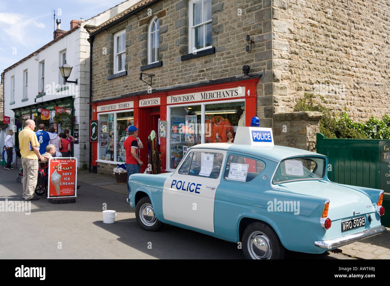 Police panda car outside Aidensfield Stores in the village of Goathland. North Yorkshire Stock Photo