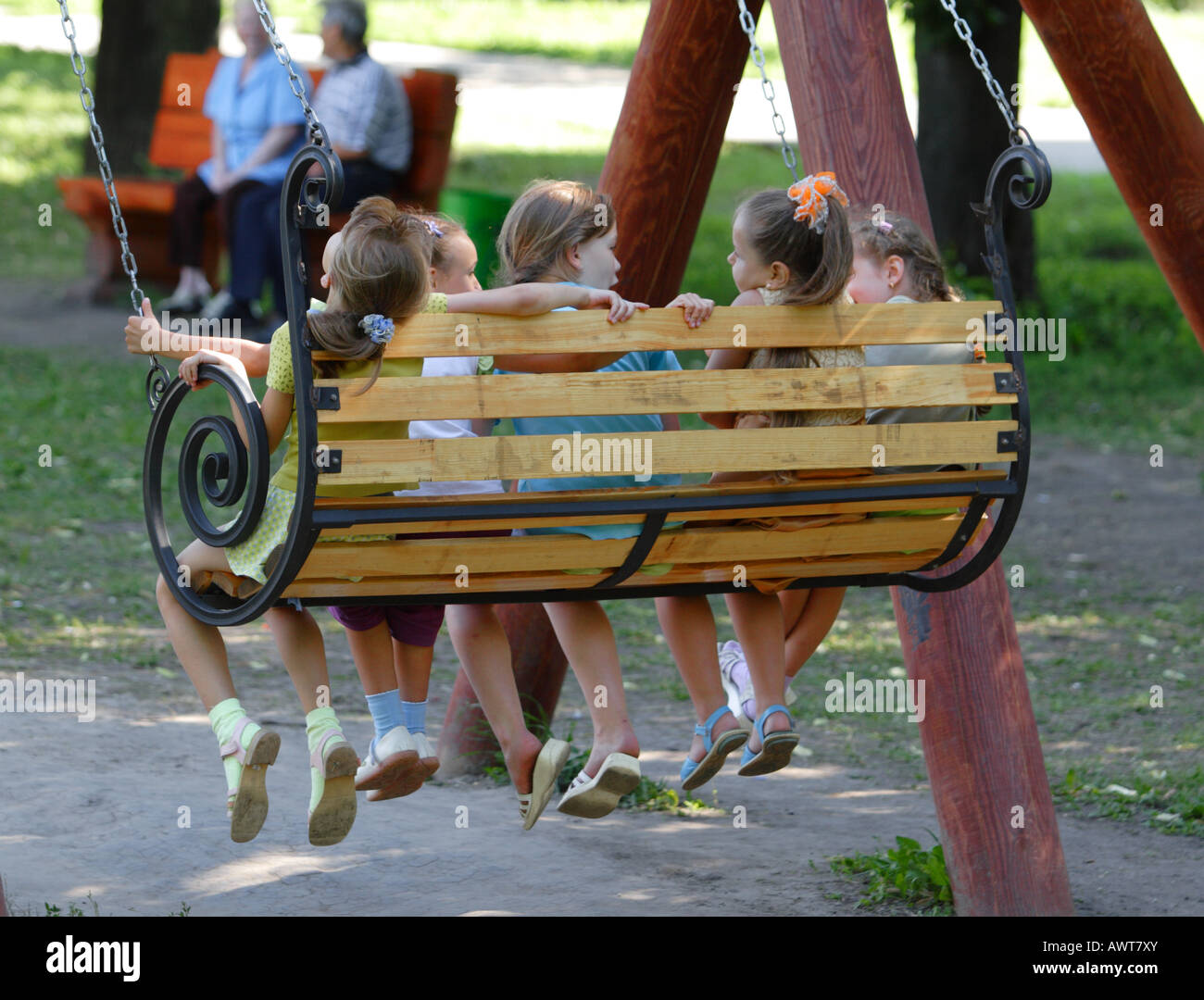 Children swinging on a swing Stock Photo Alamy