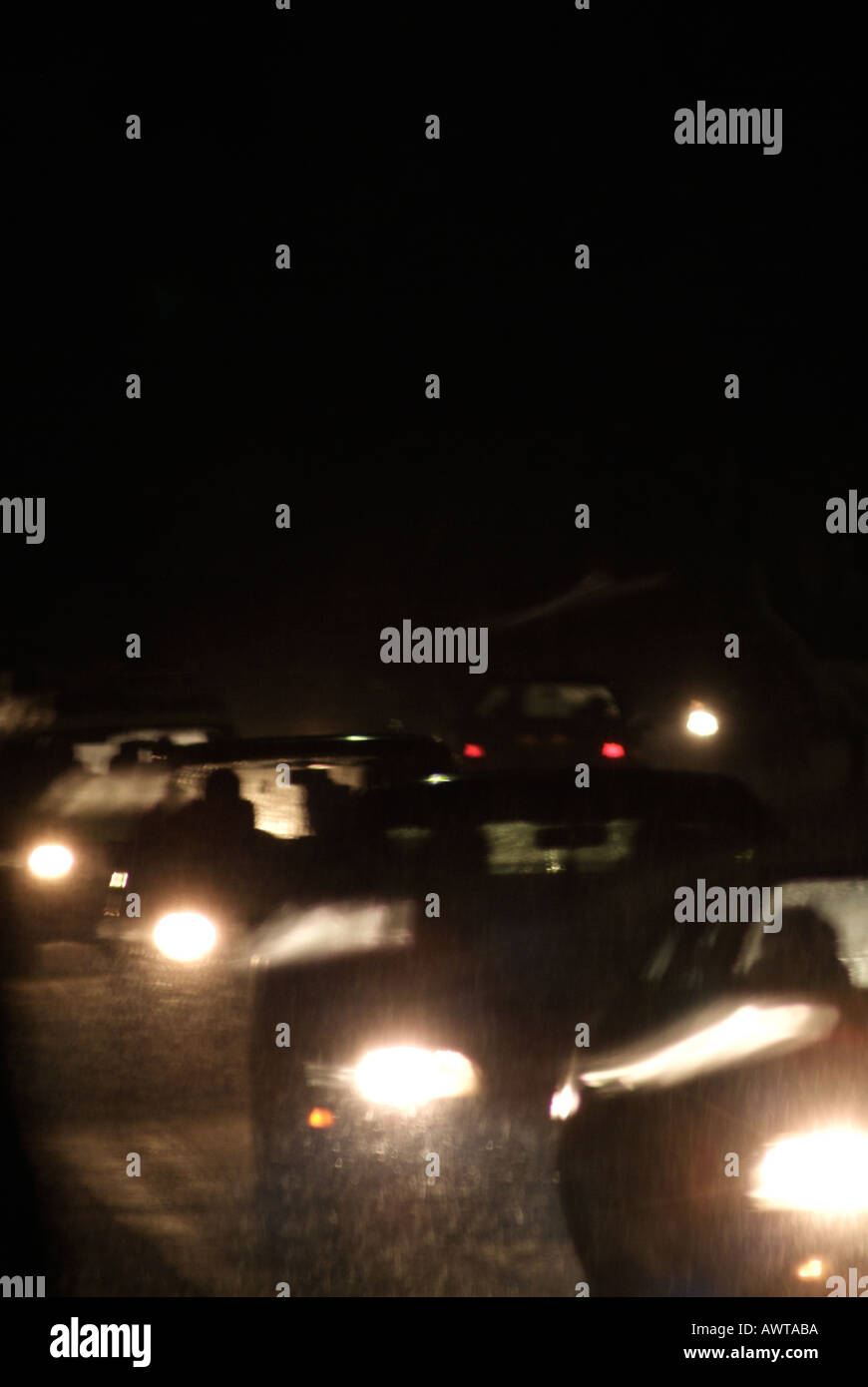 Cars on a Road at Night During a Snow Storm Stock Photo