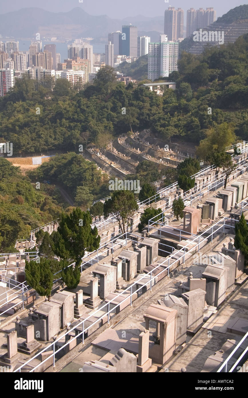 dh Chai Wan cemetery CHAI WAN HONG KONG Graveyard tombstone overlooking skyscraper housing chinese gravestones Stock Photo