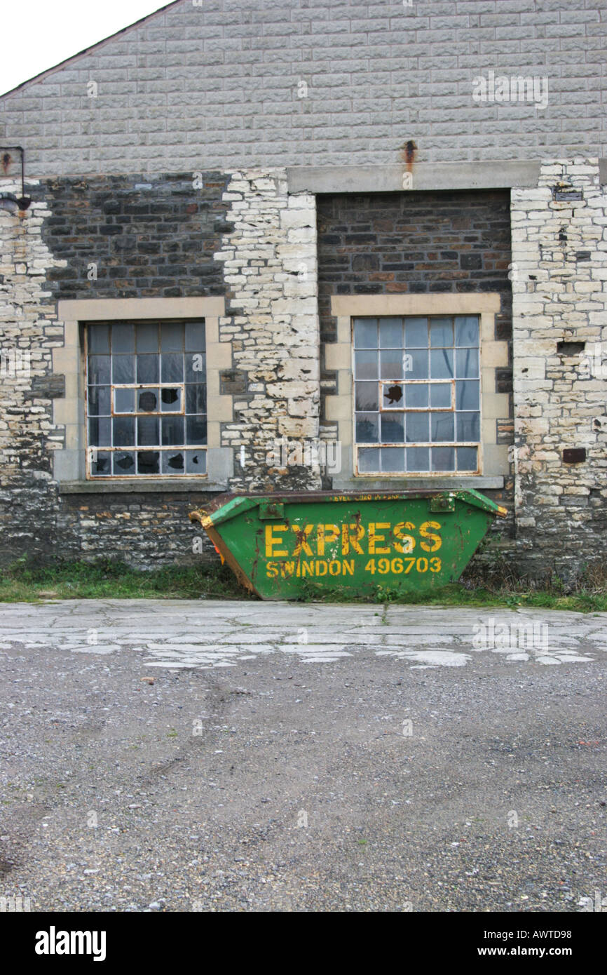 Abandoned building swindon railway works wiltshire dumpster skip Stock Photo