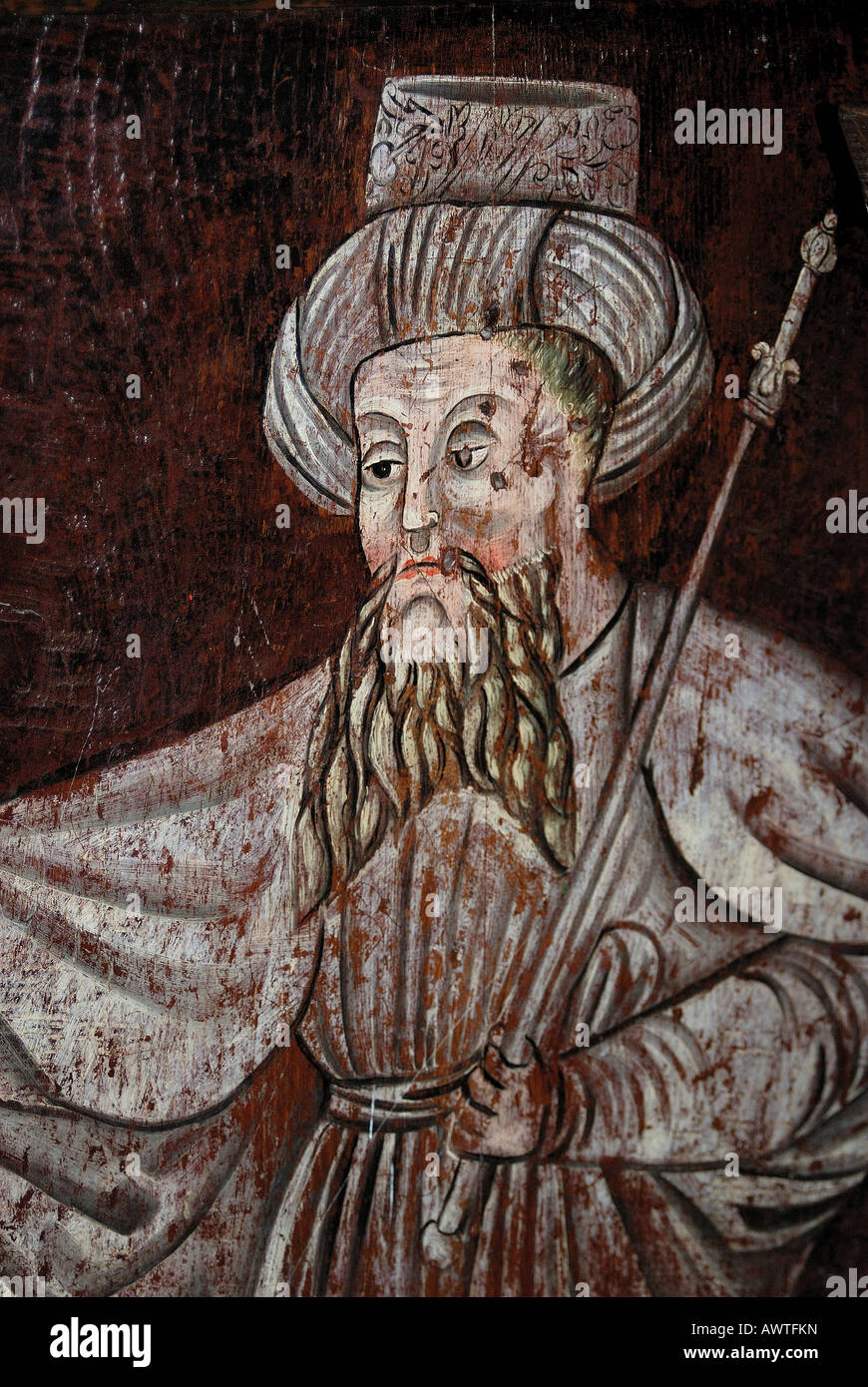 A medieval original artwork on a dark wooden panel depicting a bearded religious figure with a staff Stock Photo