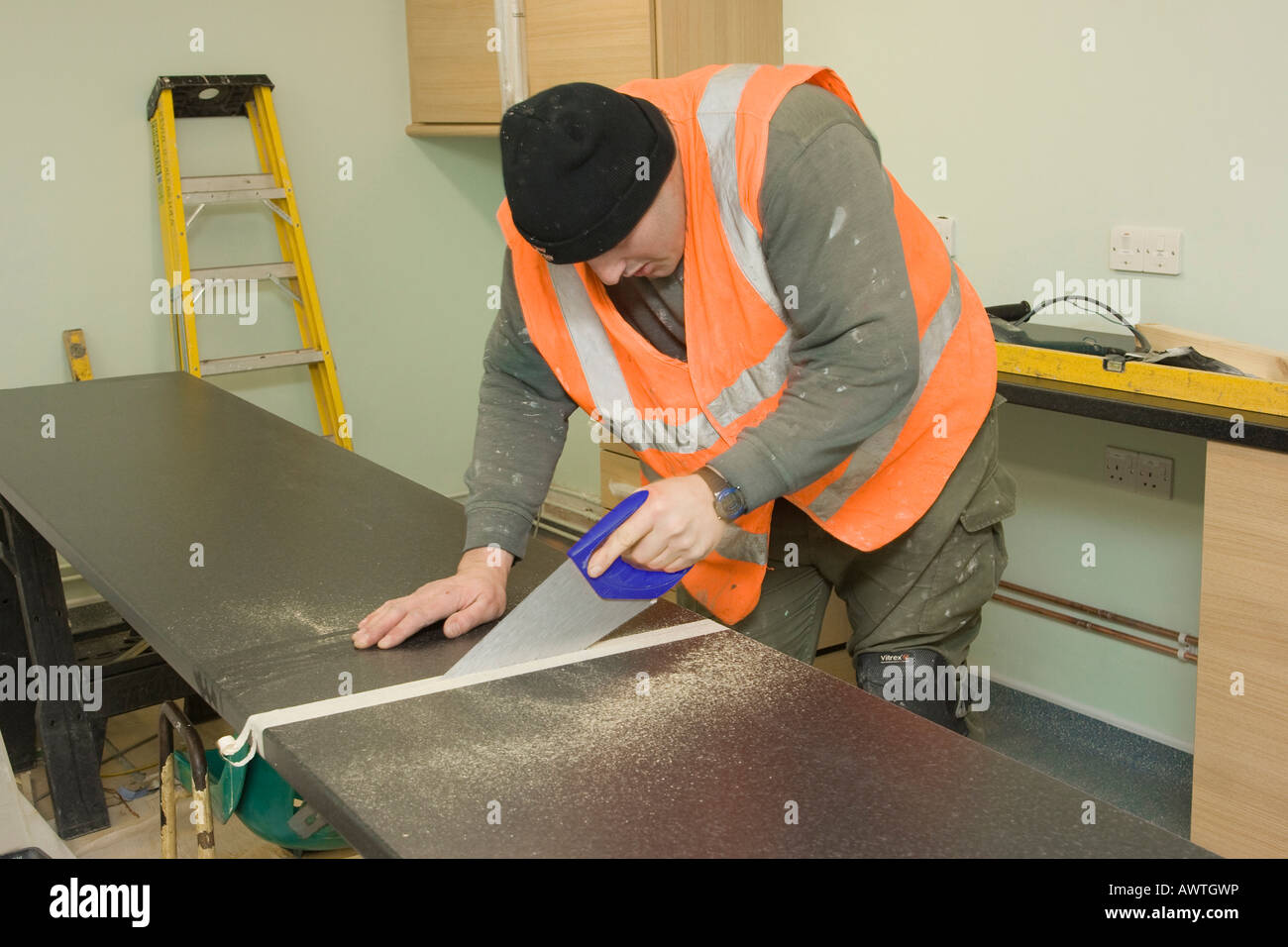 man cutting a kitchen worktop Stock Photo Alamy