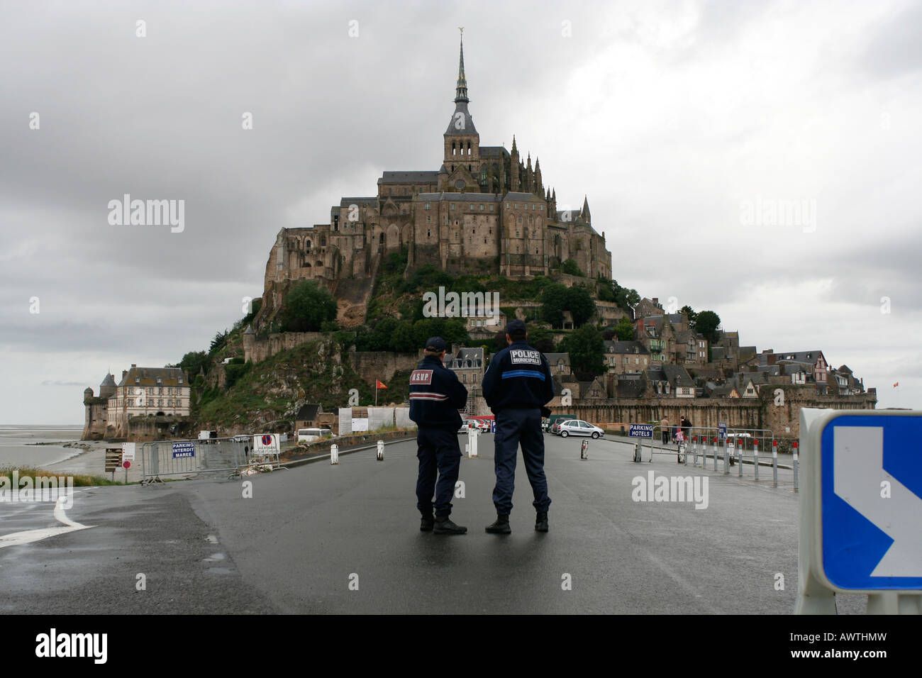 Two police officers overlooking Mont St. Michele Stock Photo