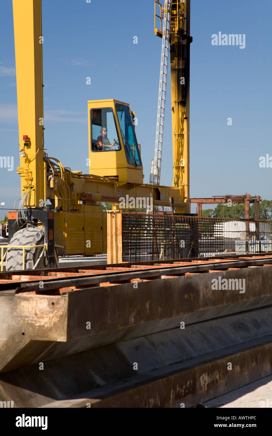 Gantry crane operator lifting heavy steel formwork Stock Photo