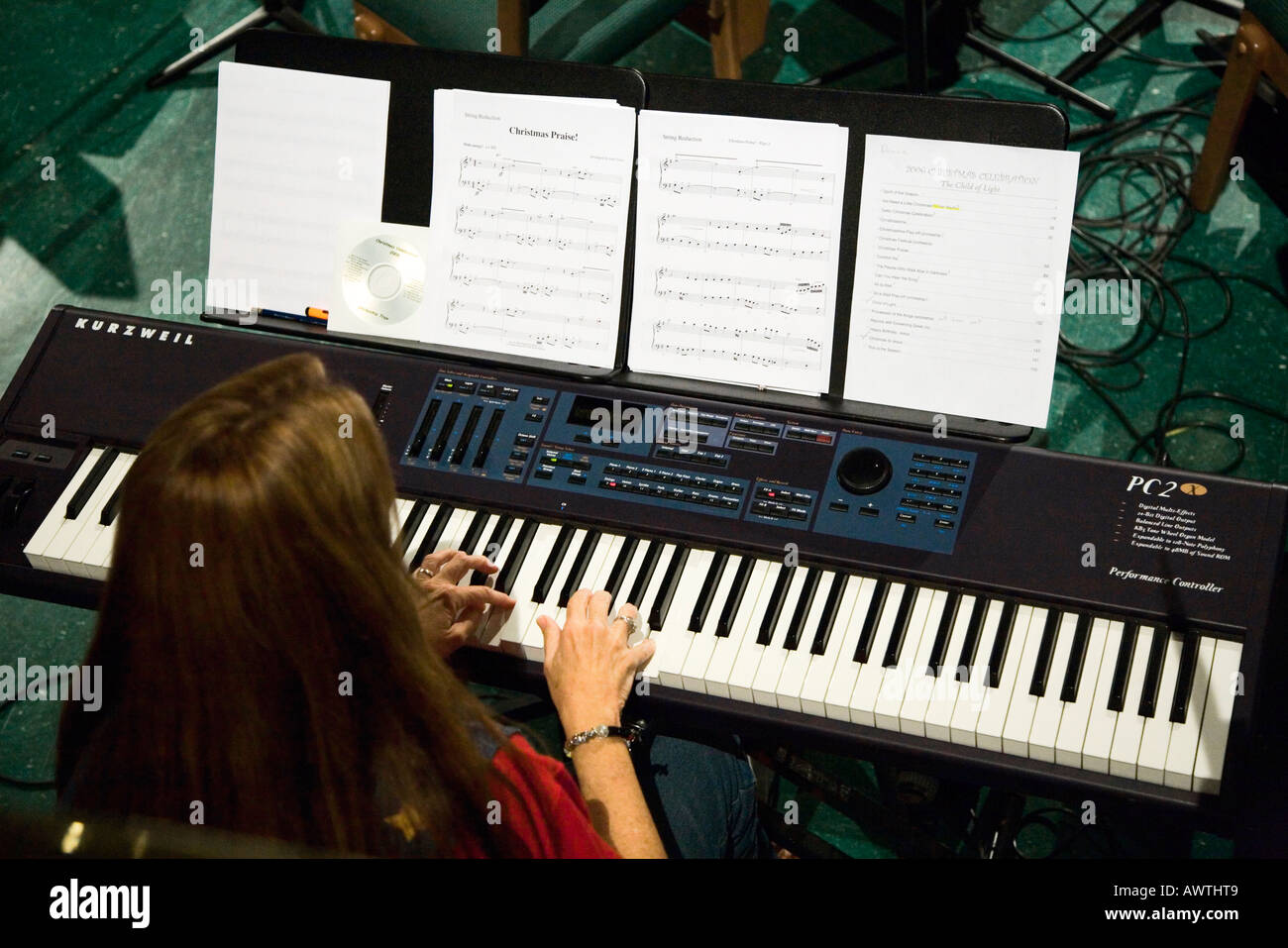 Woman playing keyboard from overhead Stock Photo