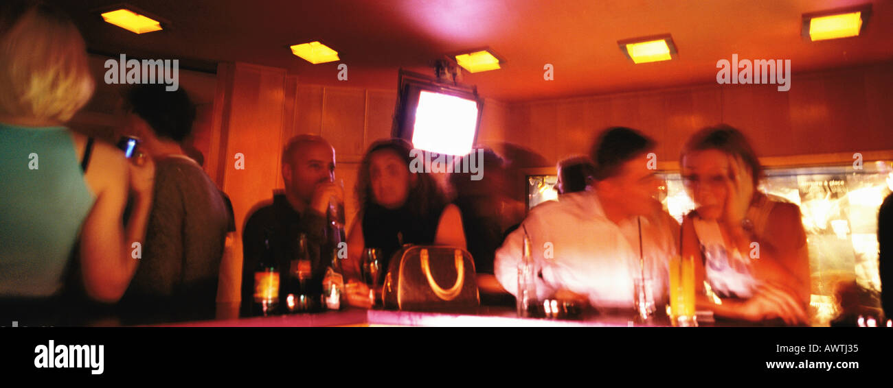People standing at bar in nightclub, blurred Stock Photo