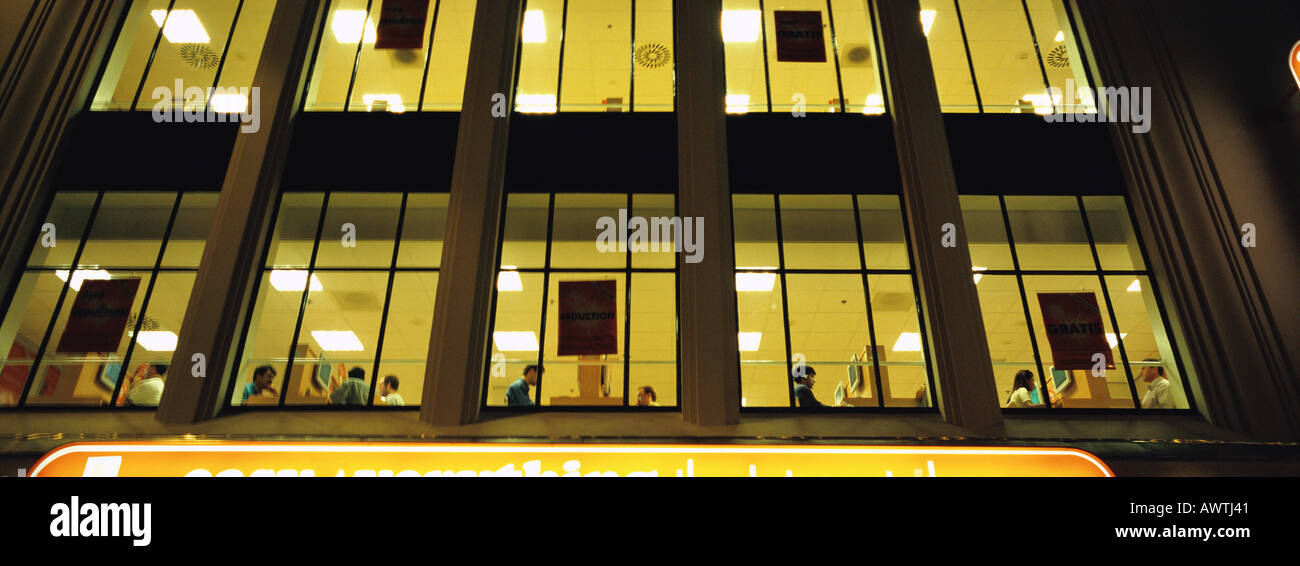 Facade of office building at night, low angle view Stock Photo