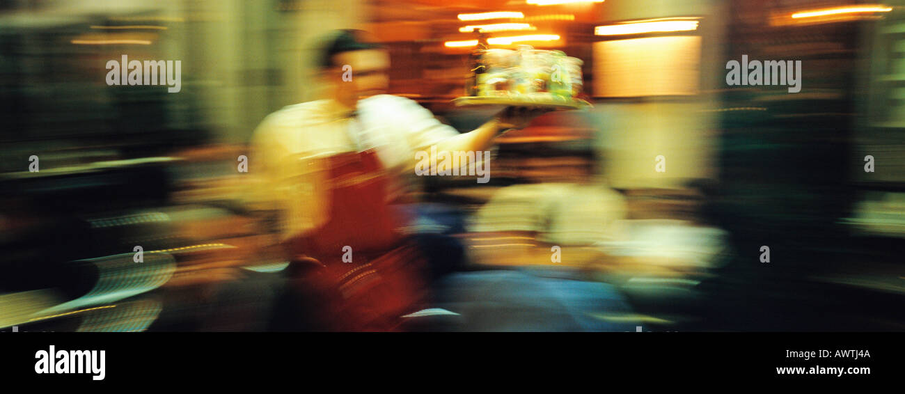 Waiter in restaurant, blurred Stock Photo