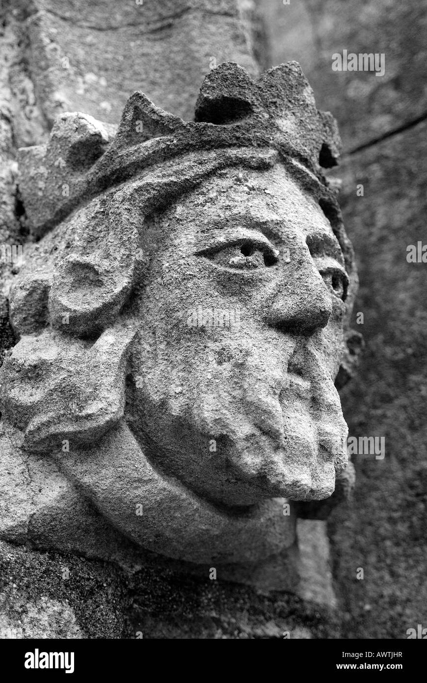 Architectural detail of a stone carved male face looking out into the distance on St James Church in Christow Devon Stock Photo