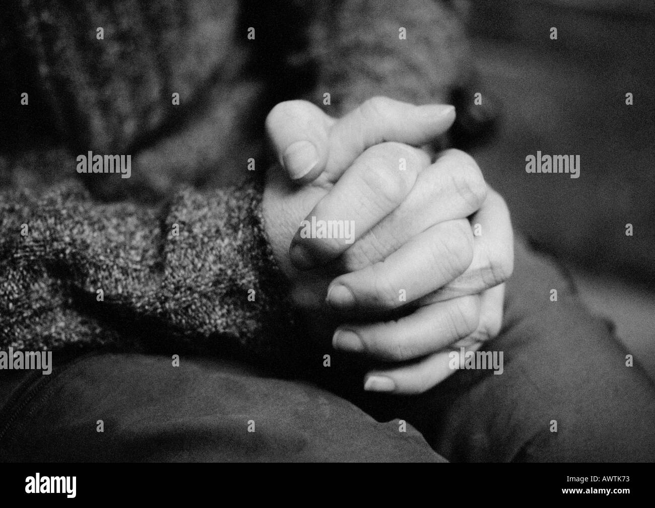 Clasped hands, close-up, b&w Stock Photo