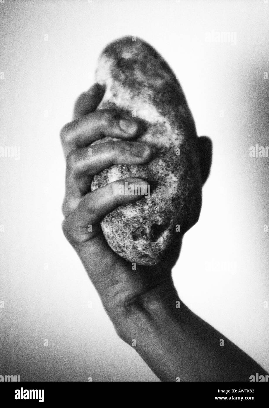 Hand holding stone, close-up, b&w Stock Photo - Alamy