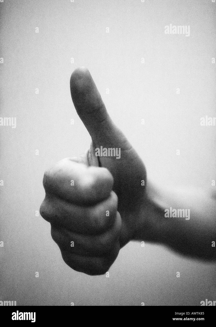 Thumb pointing up, close-up, b&w Stock Photo