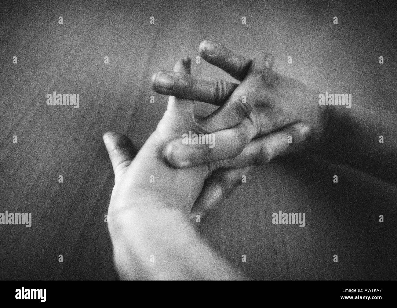 Hands together, close-up, b&w Stock Photo