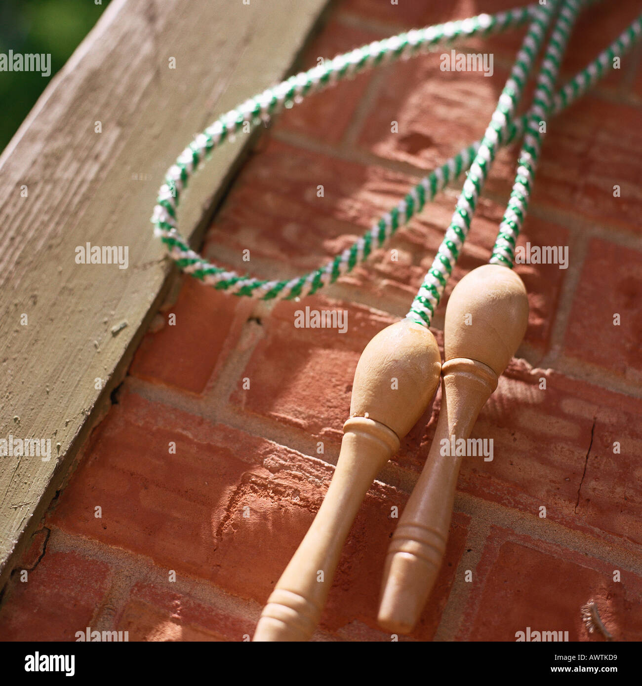 Jump rope hanging on brick wall Stock Photo Alamy