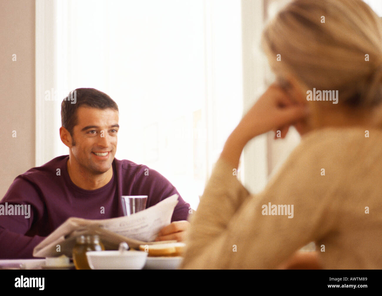 Woman sitting across from man at table, rear view Stock Photo - Alamy