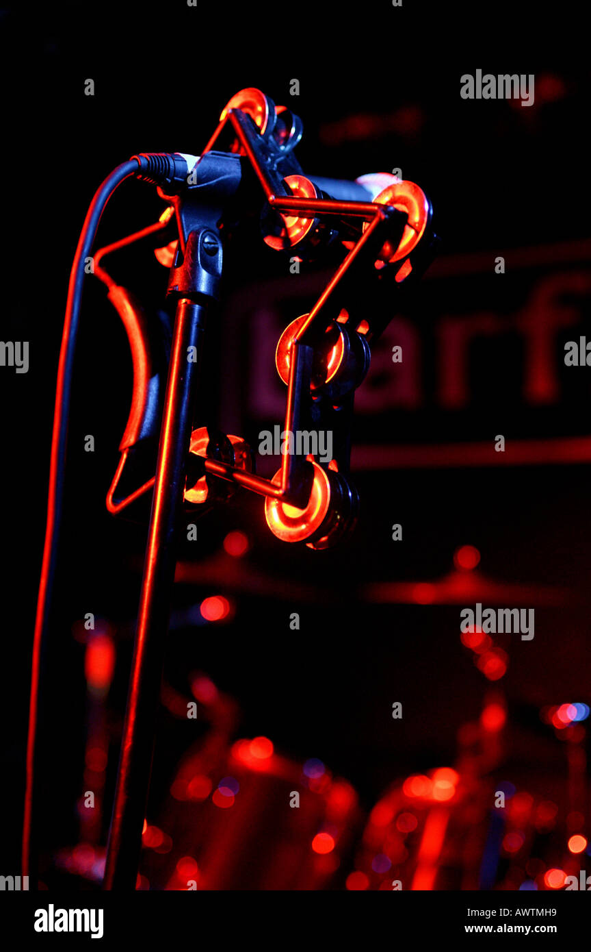A star shaped tambourine hangs on a microphone stand on stage at a ...