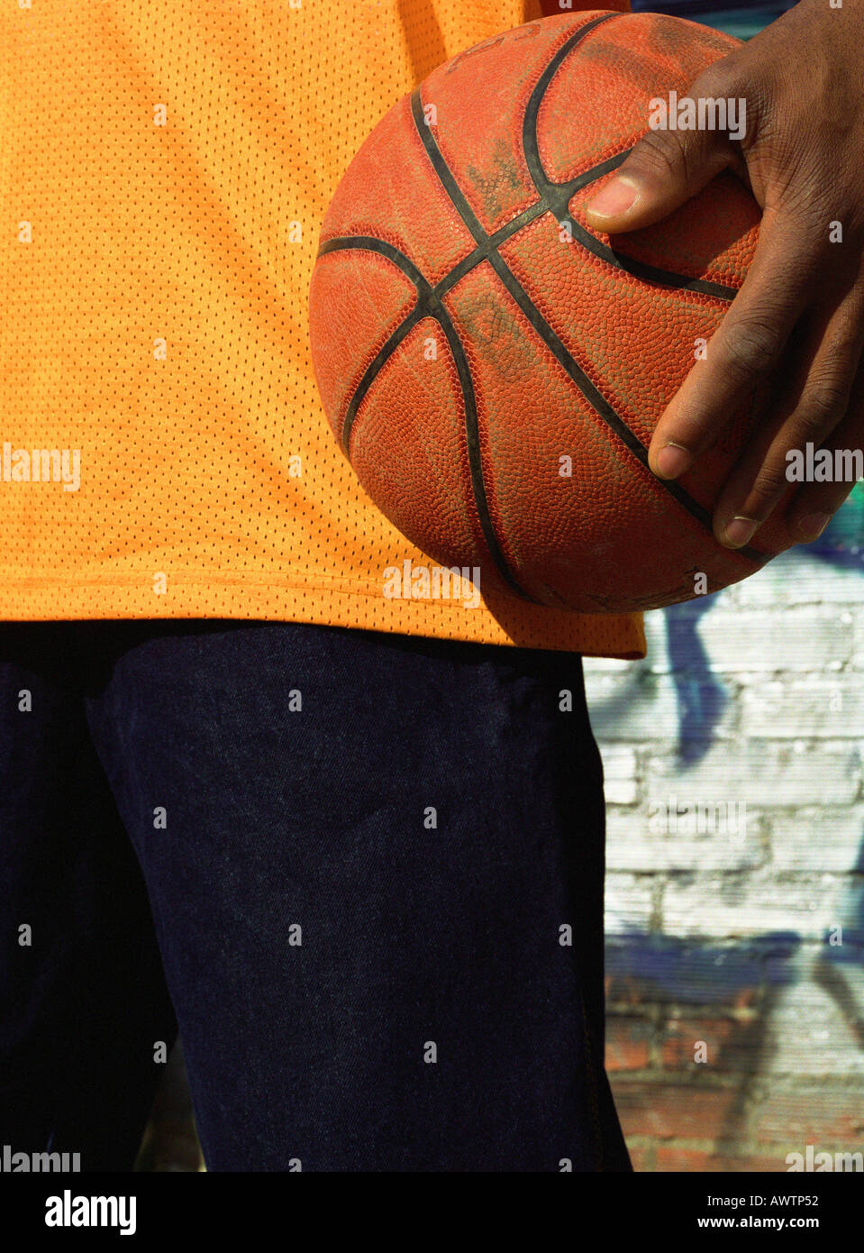 Man holding basketball, close-up Stock Photo