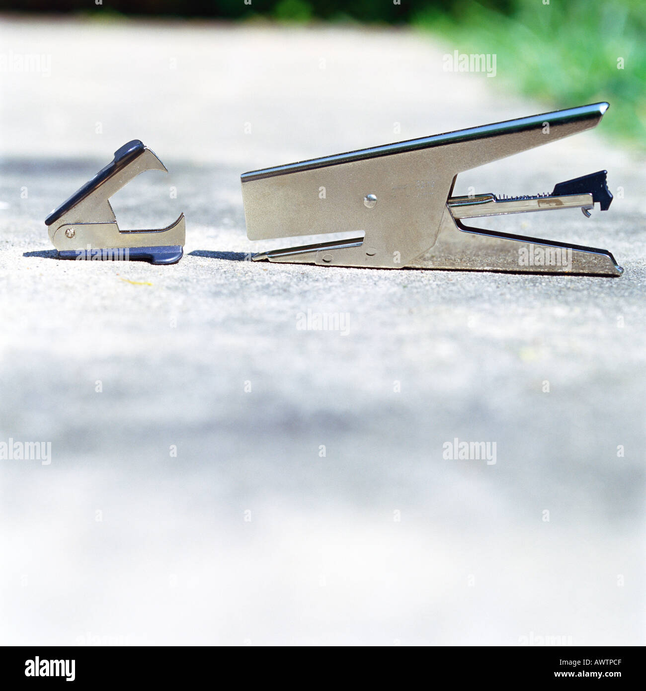 Stapler, staple remover on sidewalk Stock Photo Alamy