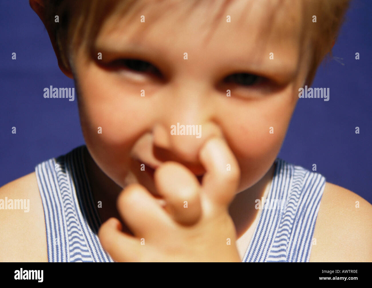 Child with finger in nose, close-up Stock Photo